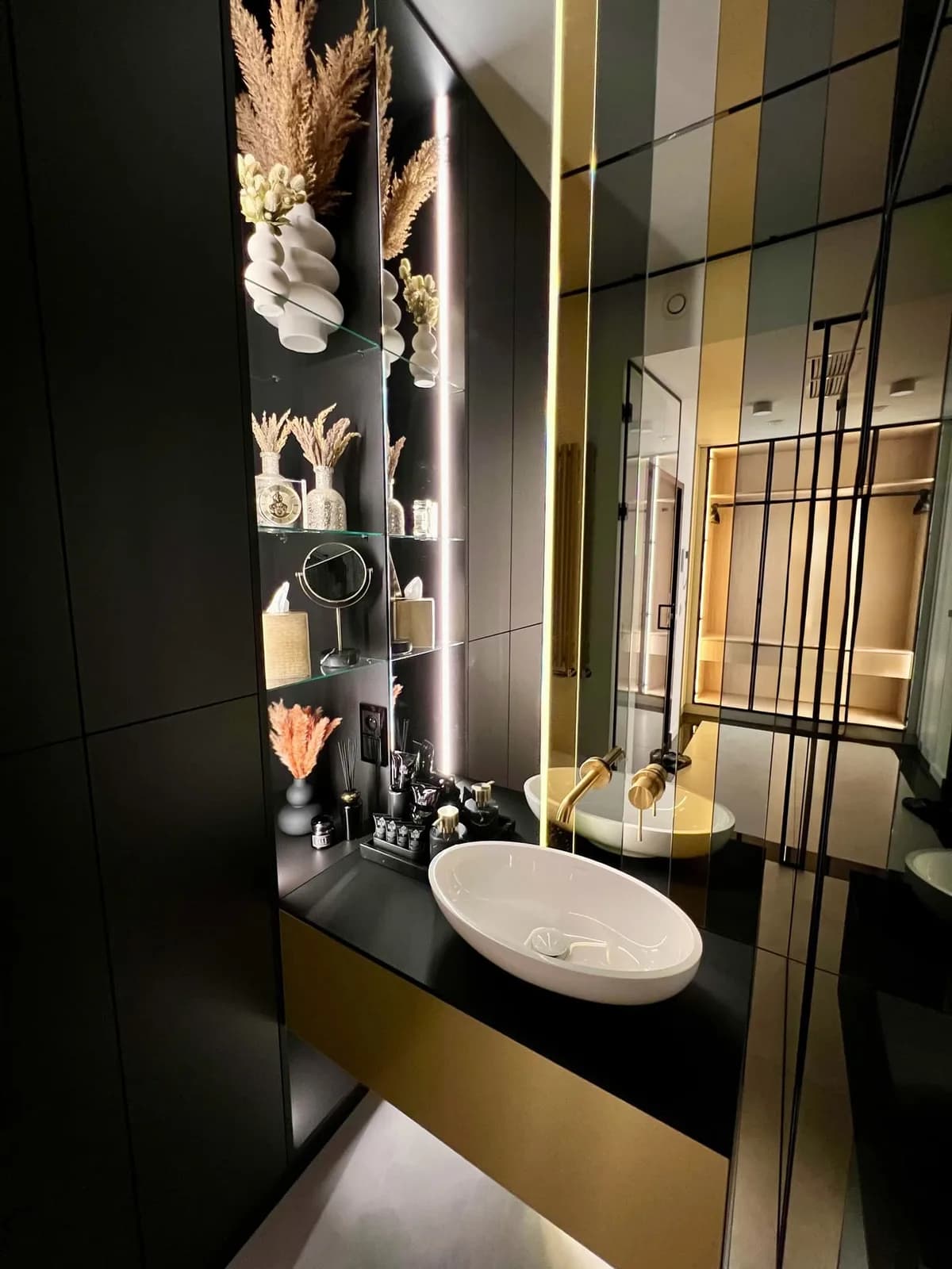Designer bathroom with decorative mirrors and gold taps