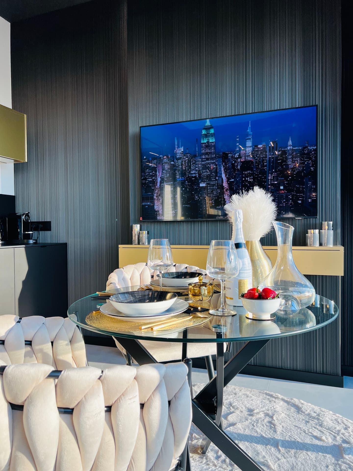 Close-up of dining table with designer tableware, champagne and fresh strawberries