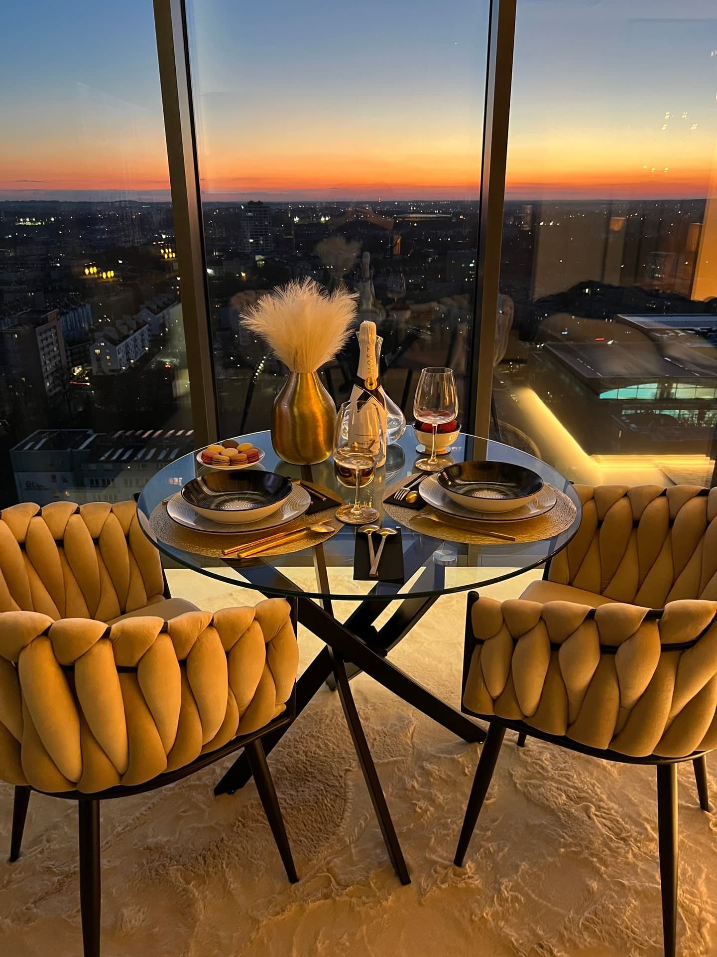 Table set for two with champagne and panoramic twilight view